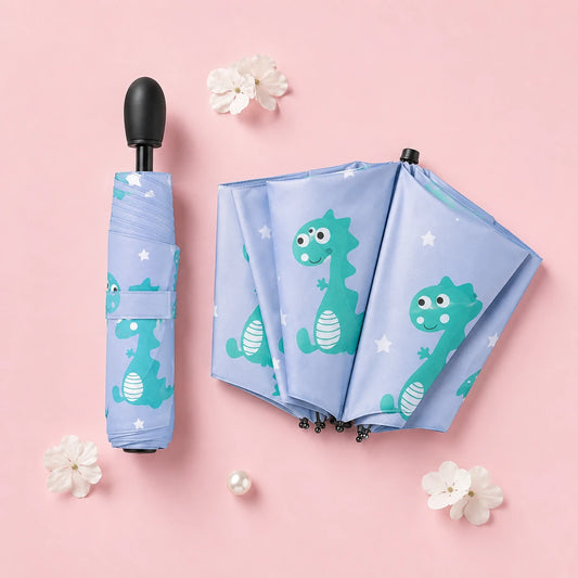 Parapluie enfant dinosaure bleu replie - flatlay fond rose pastel